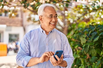 Poster - Senior man smiling confident using smartphone at park