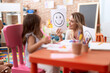 © Krakenimages.com - Teacher and toddler sitting on table having emotion therapy at kindergarten
