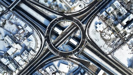 Wall Mural - Aerial drone video of urban elevated toll ring road junction and interchange overpass covered in snow during winter time