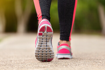 Wall Mural - fitness woman training and jogging in summer park, close up on running shoes