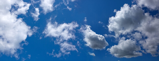 Wall Mural - Blue summer sky with fluffy clouds and blue sky background.