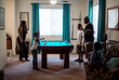 © Jelena Markovic/Stocksy - Family spending time together playing billiard