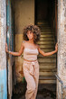 © Daniel Gonzalez/Stocksy - Stylish Cuban female touching walls and looking away