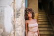 © Daniel Gonzalez/Stocksy - Cuban woman outside old building