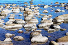 Rocks Polished By Nature In The Blue Sea