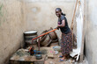 © Alvaro Lavin/Stocksy - woman drawing water from well