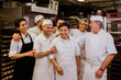© VICTOR TORRES/Stocksy - Cheerful cooks congratulating colleague in kitchen