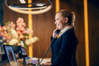 © Dusan Petkovic - A happy receptionist is answering calls at reception.