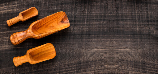 Wall Mural - Different types of wooden scoop on dark rustic table - Kitchen accessories