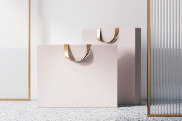 Poster - Front view on blank beige paper shopping bags with golden braids and place for your brand name on concrete floor near decorative glass partition and light wall background, 3D rendering, mockup