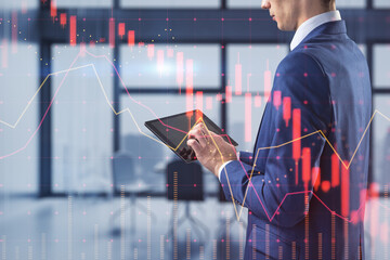 Poster - businessman using tablet with falling red forex hologram standing on blurry office interior background. Stock crisis price drop down chart fall / Stock market exchange analysis or forex graph 