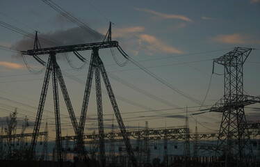 step-down transformer substation. Transformer : The equipment used to raise or lower voltage, high voltage power station. High voltage electric tower on sun set sky background. sunset heaven