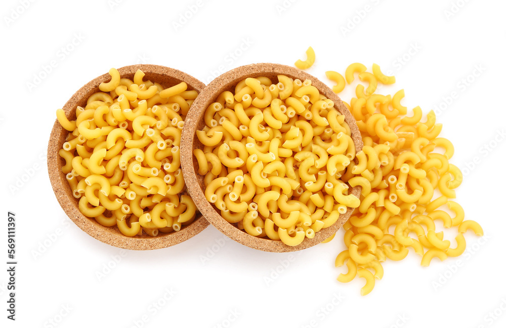 Plates of raw elbow pasta on white background