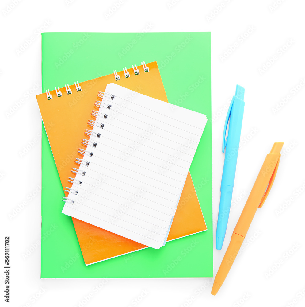 Notebooks and pens isolated on white background