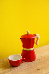 Wall Mural - Geyser coffee maker and cup on kitchen counter near yellow wall