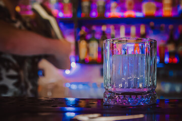 Wall Mural - empty glass with ice on a bar counter in bar or pub