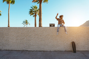 African american man listening and dancing to music outdoor - Focus on face