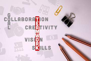 Wall Mural - teamwork concept. illustration with text and icons, crossword puzzle. stationery on the table