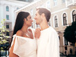 © halayalex - Smiling beautiful woman and her handsome boyfriend. Happy cheerful family. Sexy couple posing in the street at sunrise. During romantic date at sunny summer day outdoors. Looking at each other