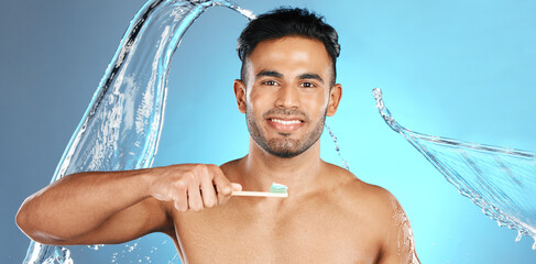 Canvas Print - Dental, portrait and man brushing teeth in water splash, studio and mockup on blue background. Oral, hygiene and male teeth model with brush for mouth, cleaning and whitening product while isolated