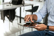 © Panorama - A closeup of a man holding his tablet and zooming in