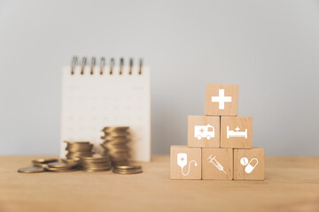 Wall Mural - For world health day, wellness, wellbeing, insurance, health check up, retirement plan concept. Medical sign on arranged wooden cube block and blurred stack of coins and calendar