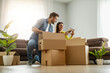 © ivanko80 - Smiling couple unpaking boxes in new home