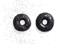 2 Black Bagels With Salt And Poppy Seeds On A White Background