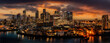 Canary Wharf and London city skyline at dusk with setting sun and street lighting looking at finance and business district of the city of London, united kingdom. Aerial view with dramatic sunset