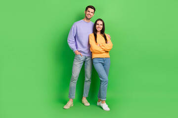 Wall Mural - Full length photo of two positive peaceful people hugging toothy smile isolated on green color background