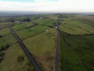 Wall Mural - Aerial view of a country road surrounded by farmland and fields. Taken in Bury Lancashire England. 