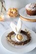 © Olja Reka - Festive Easter table setting with Easter bunny made of linen napkin and yellow egg