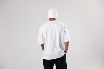 Man in a white t-shirt and panama. Mock-up. Back view.