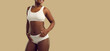 © Studio Romantic - Narrow banner crop shot of smiling African American girl in underwear isolated on yellow studio background. Curvy black woman in lingerie feel body positive. Fashion and style. Copy space.