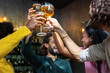 © Xavier Lorenzo - Young group of multiracial people toasting cold beer at happy hours brewery bar. After work concept