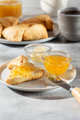 Wall Mural - Traditional British scones served with orange jam on gray background.