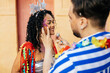 © kleberpicui - Brazilian Carnival. Reveler retouching makeup during carnival block.