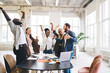 © BullRun - Group of diverse colleagues celebrating victory