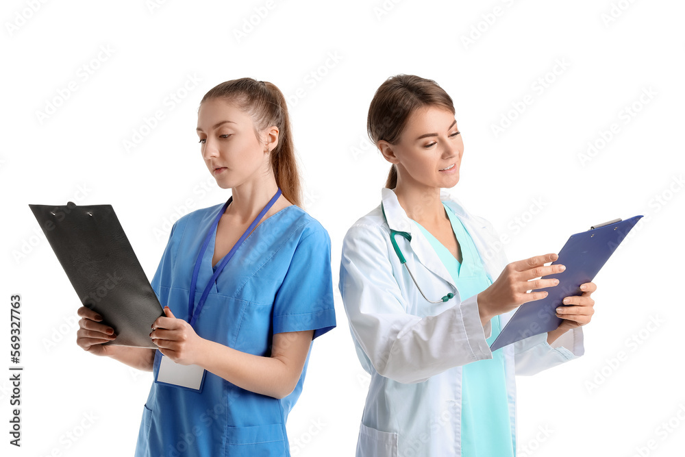 Female doctor and intern with clipboards on white background