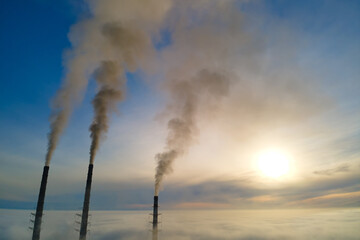 Wall Mural - Aerial view of coal power plant high pipes with black smoke moving up polluting atmosphere at sunset