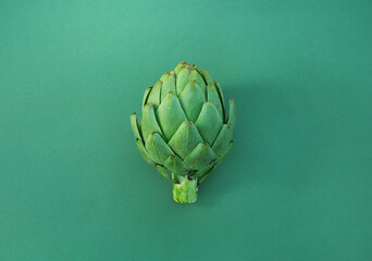 Canvas Print - Whole fresh raw artichoke on green background, top view. Space for text