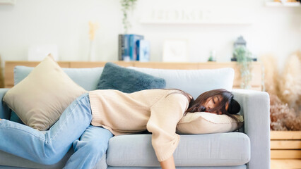 asian woman resting at home on couch, feeling exhausted after work, lacking energy, or overworked, t