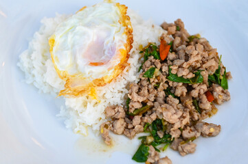 Wall Mural - holy basil minced pork, Stir fried Thai basil with minced pork and a fried egg on white plate