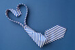 Necktie in heart shape on blue background