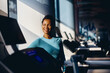 © Drazen - Happy African American female athlete in gym looking away.
