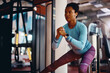 © Drazen - Black female athlete doing side lunges during sports training in gym.