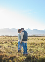 Canvas Print - Love, interracial and couple on countryside vacation, holding hands and joyful outside with romantic view. Romance, happy man and black woman on field, holiday and weekend break, happiness or support