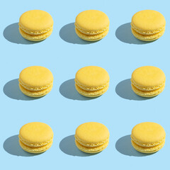 Wall Mural - Seamless pattern with yellow macaron on blue background.