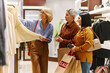 © Seventyfour - Happy women shopping for clothes in boutique