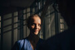 © Maskot - Sunlight falling on face of young female nurse in hospital